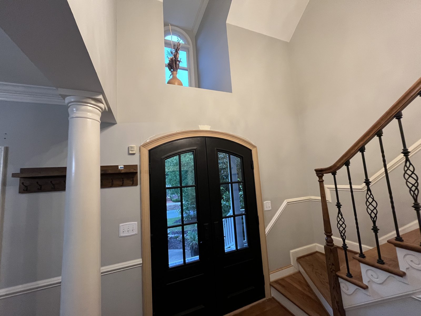 Entry foyer with arched double doors before painting
