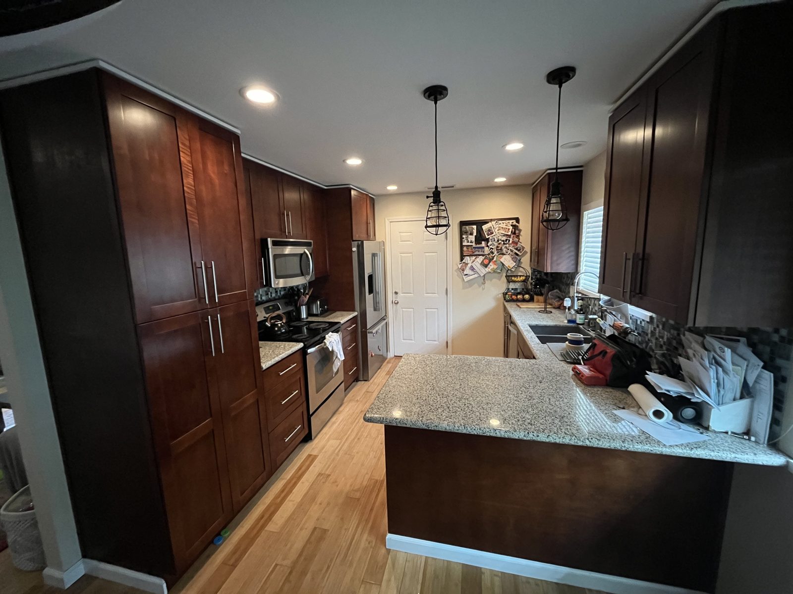 Kitchen with dark brown cabinets before painting